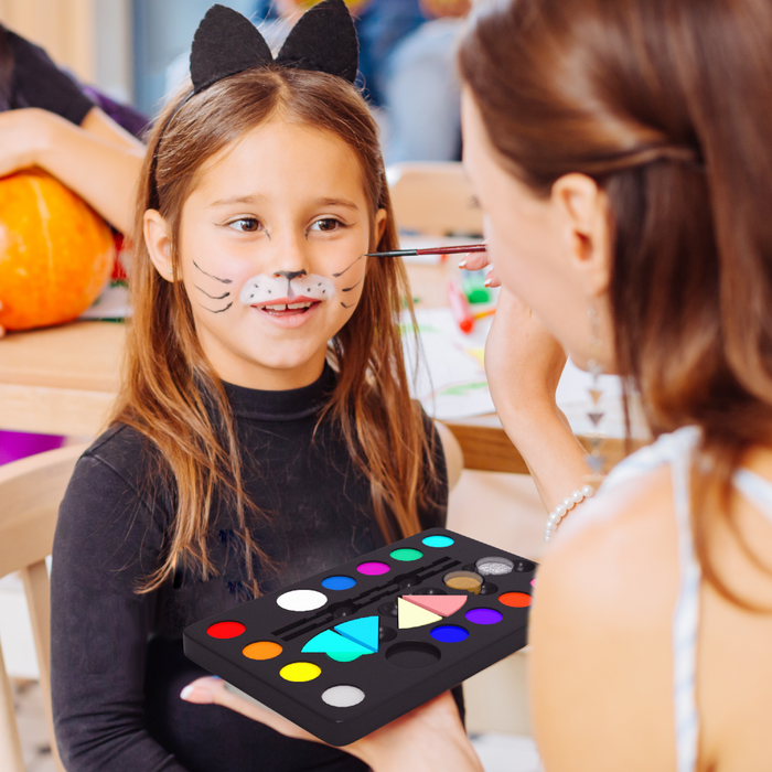 Woman draw on girl face 
